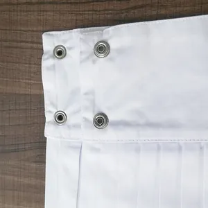 Elegant decorative white pleated shirt cuffs featuring metal snap buttons on wood