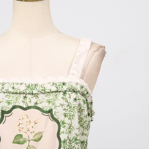 Close-up detail of floral print camisole dress with elegant pearl trim and ruffles
