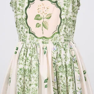 Macro view of a vintage floral print dress showing waist detail and leaf pattern