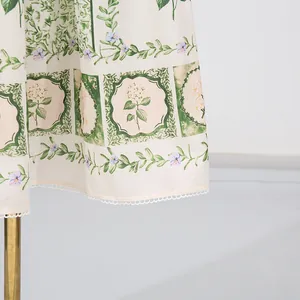 Close-up detail of the hem on an elegant floral print forest style suspender dress