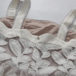 Detalle del bordado de hojas pesadas y empalme de malla en un vestido de estilo francés