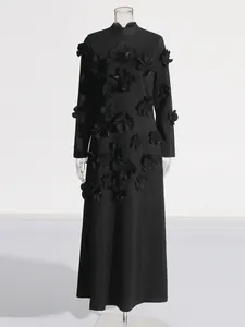 Elegant black long-sleeved maxi dress with 3D floral appliqués and a stand collar