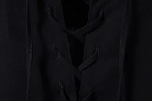 Macro detail of the adjustable lace-up neckline on black cotton linen Henley shirt