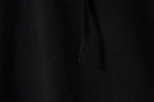 Close-up of black cotton linen fabric texture and stitching on long sleeve Henley shirt