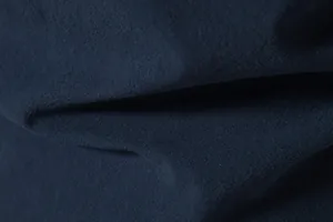 Detailed macro shot of navy blue cotton-linen fabric texture for men's beach shirt