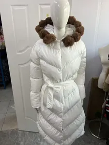 Elegant white long puffer coat featuring a brown faux fur hood and belted waist detail
