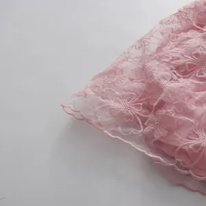 Close-up detail of pink floral lace fabric on an elegant vintage-style dress