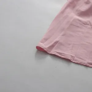 Close-up detail of the pink elegant retro high-waisted dress hemline