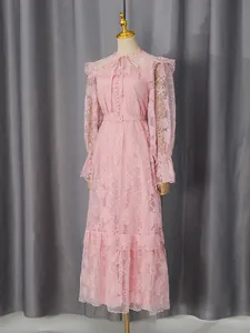Elegant pink floral lace maxi dress with lantern sleeves and waist belt on mannequin