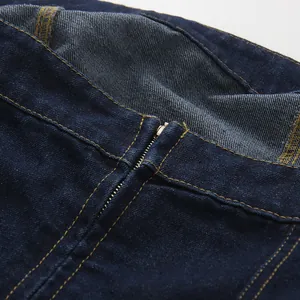 Close-up of the metal zipper and contrast stitching on this dark blue denim tube top.