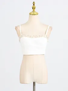 Elegant white spaghetti strap crop top featuring exquisite beaded neckline detail