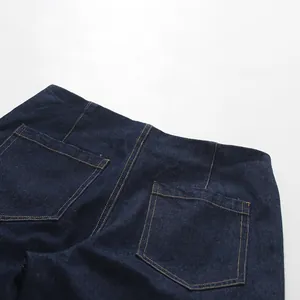Close-up view of the back pockets and stitching on high-waisted dark blue denim jeans.