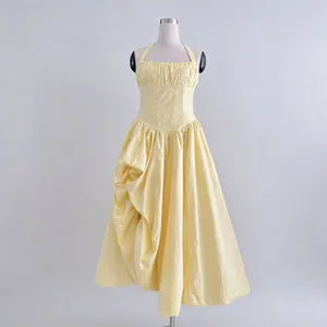 Elegant pale yellow halter long dress with pleated bodice and flared skirt detail