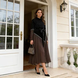 Elegant long-sleeved dress featuring a black velvet top and brown pleated mesh skirt
