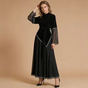 Elegant black pleated long dress featuring mesh sleeves and shimmering velvet bodice