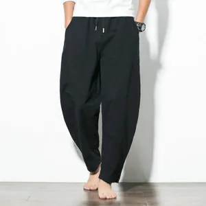 Front view of men's loose fit black harem pants with a comfortable drawstring waist