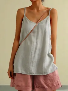 Close-up detail of light grey cotton linen camisole showing delicate straps and texture