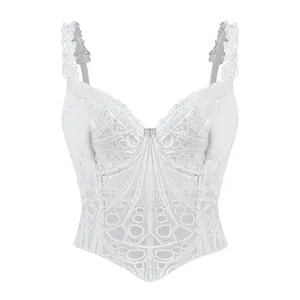 Vista dettagliata di un corsetto bianco in pizzo vintage francese con motivi floreali.