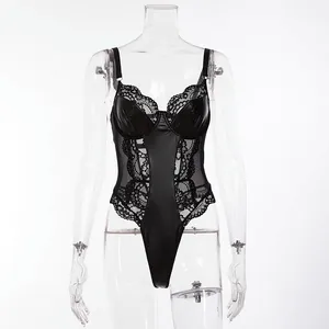 Detailed view of a black faux leather and lace patchwork bodysuit on a clear mannequin