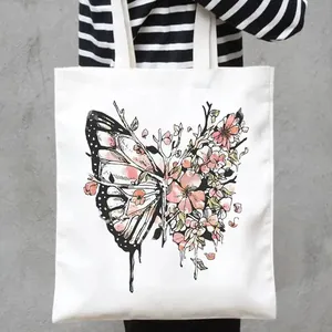 Detailed close-up view of a white canvas tote bag with artistic butterfly floral print