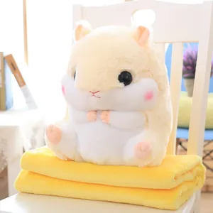Detail view of cute hamster plush toy sitting on a soft yellow folded nap blanket
