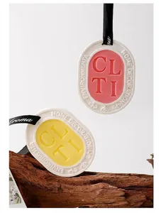Close-up of pink and yellow wardrobe aroma wax tablets hanging on a rustic wood prop