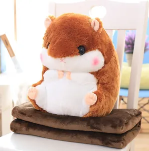 Detailed view of cute brown hamster plush pillow and matching soft brown folded blanket