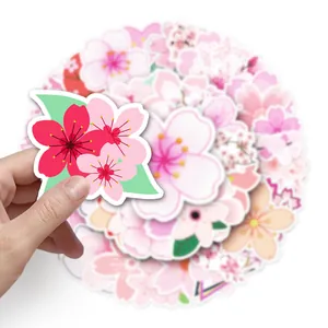 Detailaufnahme eines rosa Kirschblüten-Aufklebers, von Hand gehalten