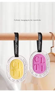 Detail of yellow and pink wardrobe fragrance wax tablets hanging on a wooden rail