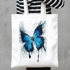 Fashionable white canvas tote bag with artistic blue butterfly print for daily shopping