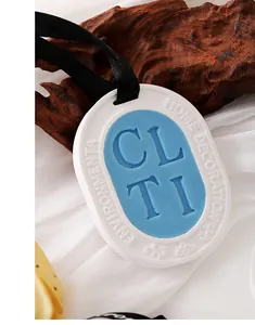 Close-up of elegant gypsum aroma wax sachet with blue wax center and black ribbon