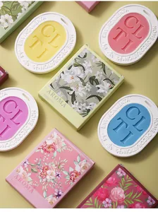 Close-up detail of various colorful plaster scented wax tablets and floral gift boxes.