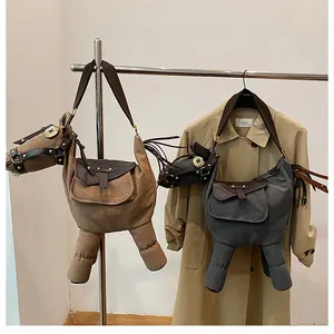 Detail view of two quirky donkey-shaped canvas crossbody bags in brown and grey colors