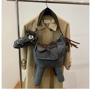 Unique donkey-shaped grey canvas crossbody bag with leather trim and gold studs.