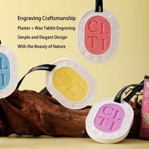 Handmade plaster aromatherapy wax tablets for closet with floral scent and black ribbon