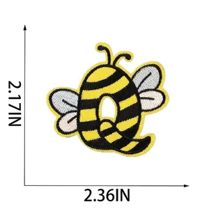 Detailed dimensions of bee-themed letter Q embroidered patch showing 6cm width and 5.5cm height