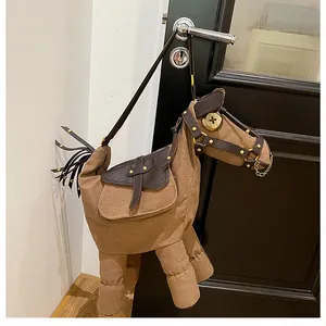 Artistic donkey-shaped canvas crossbody bag shown hanging from a vintage door handle