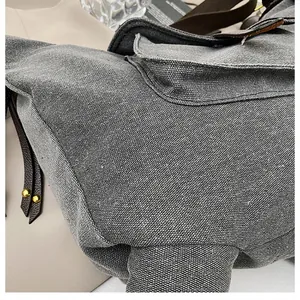 Close-up detail of high-quality gray canvas material on quirky donkey-shaped crossbody bag.