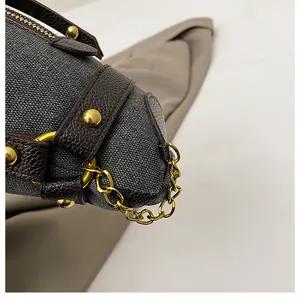 Close-up detail of a niche donkey-shaped canvas crossbody bag with gold chain decoration