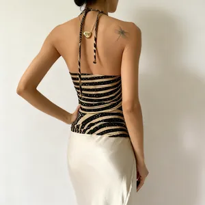 Detail view of a sexy zebra print halter neck backless top with shimmering sequins deco.