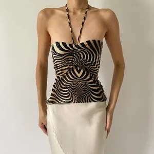 Close-up view of a sexy sequined zebra print halter neck backless top for women