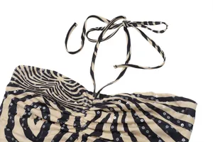 Close-up view of a stylish zebra print halter top featuring pleated fabric and sequins