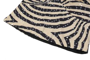 Close-up of zebra print fabric with shimmering sequin details on a sexy halter top.