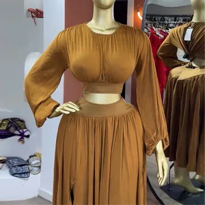 Zweiteiliges Set mit Laternenärmel-Crop-Top und plissiertem Maxirock auf einer Schaufensterpuppe.