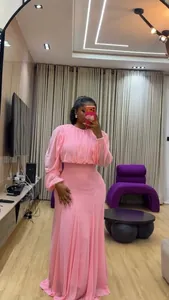 Vista completa del set elegante con camicetta a maniche a sbuffo rosa e gonna lunga a vita alta