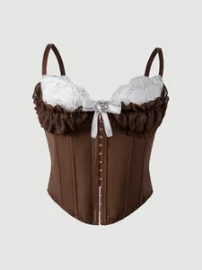 Close-up detail of a brown corset top featuring white lace embroidery and ruffle trim