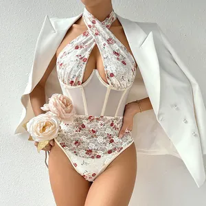 Dettaglio ravvicinato di un body sexy con scollo all'americana in pizzo floreale e corsetto