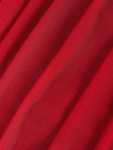 Detailed macro shot showing the fine texture of breathable red mesh corset fabric.