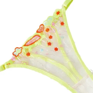 Vue détaillée du string en maille transparente jaune fluo avec broderie florale