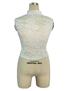 Macro detail of the elegant white floral lace pattern on this slim fit hollow crop top